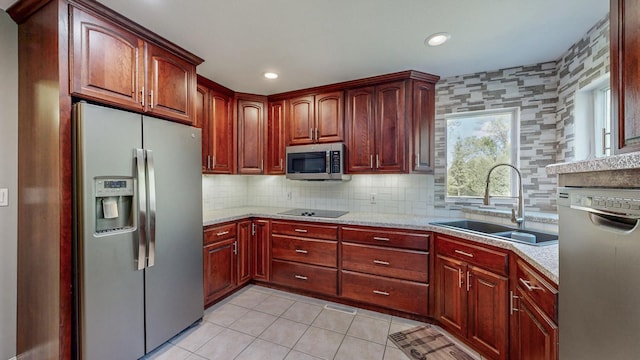 610 Main St, Adams, MN 55909 - kitchen with stainless steel appliances, a sink, light tile patterned flooring, tasteful backsplash, and dark brown cabinets