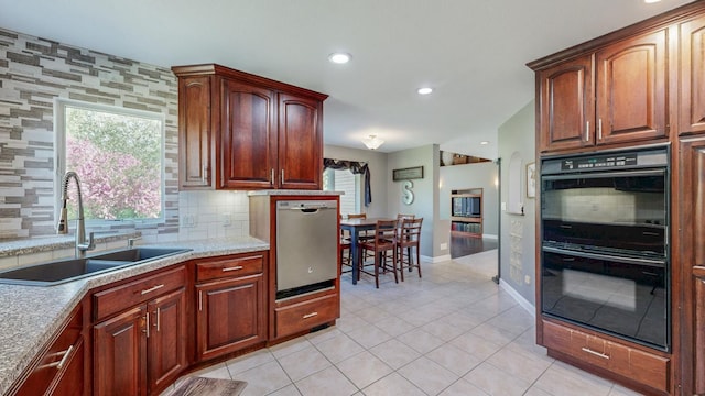 610 Main St, Adams, MN 55909 - kitchen with a sink, dishwasher, light tile patterned flooring, baseboards, and decorative backsplash