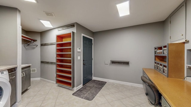 610 Main St, Adams, MN 55909 - laundry area with washer / dryer, light tile patterned floors, cabinet space, and baseboards