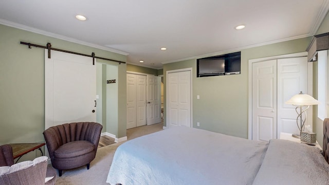 610 Main St, Adams, MN 55909 - bedroom featuring a barn door, recessed lighting, multiple closets, ornamental molding, and baseboards