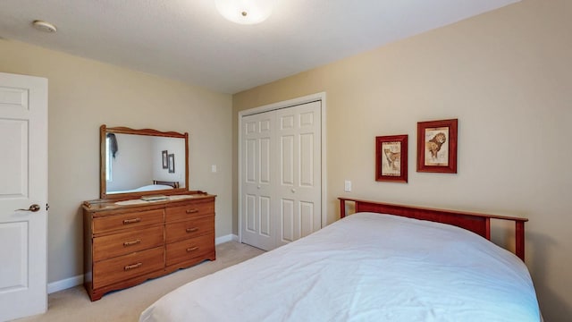 610 Main St, Adams, MN 55909 - bedroom featuring light carpet, a closet, and baseboards