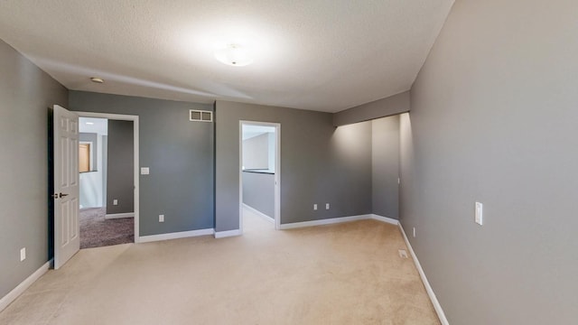 610 Main St, Adams, MN 55909 - unfurnished bedroom featuring light colored carpet, baseboards, and a textured ceiling