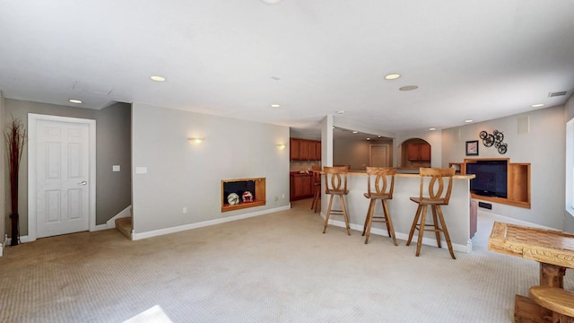 610 Main St, Adams, MN 55909 - kitchen with a kitchen breakfast bar, light carpet, baseboards, recessed lighting, and a center island