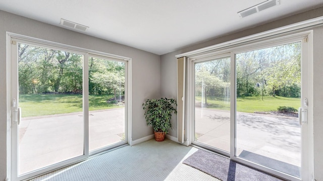 610 Main St, Adams, MN 55909 - doorway to outside featuring carpet floors and baseboards