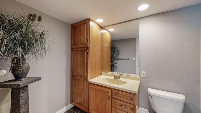 610 Main St, Adams, MN 55909 - bathroom featuring toilet, recessed lighting, vanity, and baseboards
