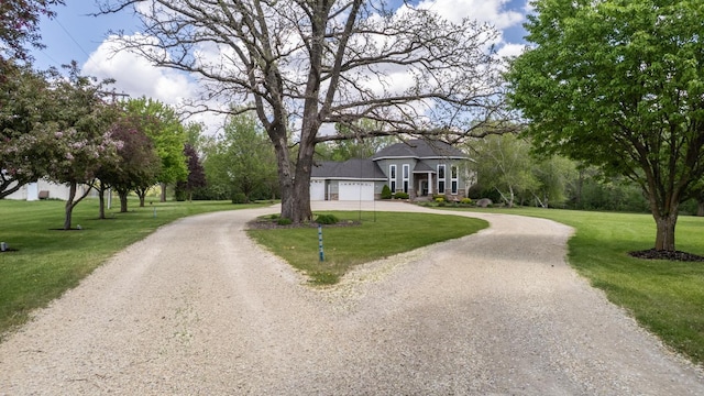 610 Main St, Adams, MN 55909 - view of front facade featuring curved driveway, a front lawn, and an attached garage