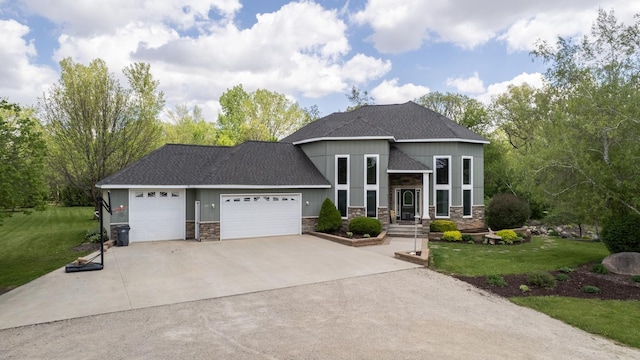 610 Main St, Adams, MN 55909 - view of front facade featuring stone siding, a garage, driveway, and a front yard