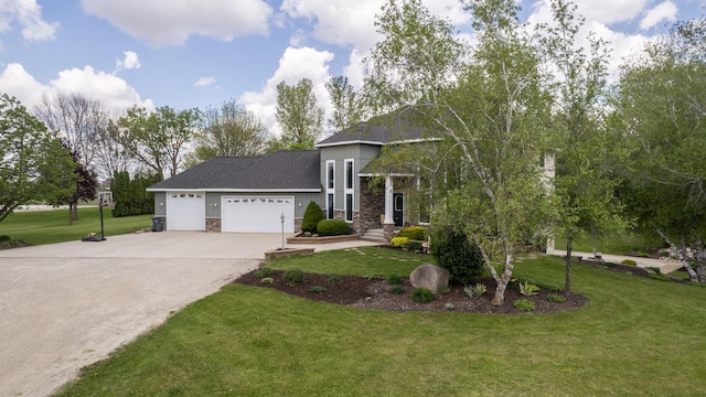 610 Main St, Adams, MN 55909 - view of front of property with stone siding, driveway, a front lawn, and a garage