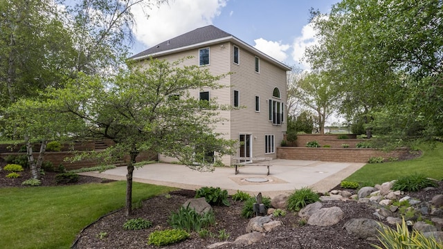 610 Main St, Adams, MN 55909 - back of property featuring a patio and a lawn