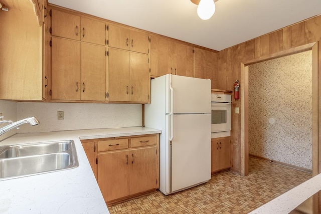 468 Washington St, Le Center, MN 56057 - kitchen with white appliances, a sink, light countertops, and light floors