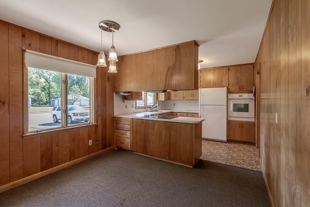 468 Washington St, Le Center, MN 56057 - kitchen featuring white appliances, a peninsula, brown cabinetry, light countertops, and wood walls