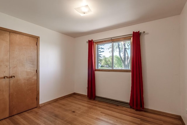 468 Washington St, Le Center, MN 56057 - unfurnished bedroom featuring light wood-style flooring, a closet, and baseboards