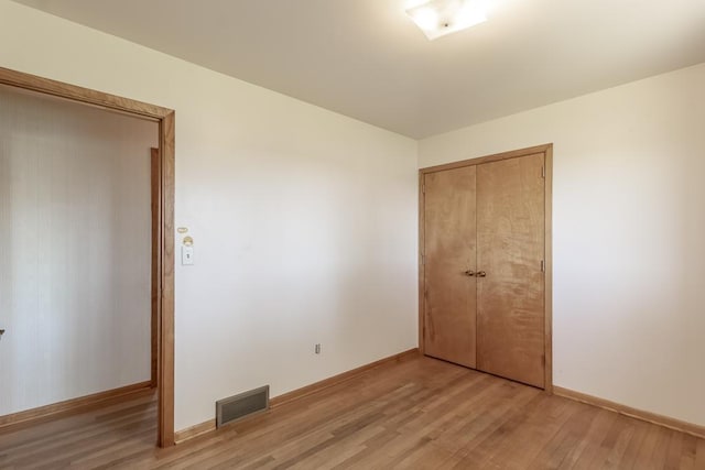 468 Washington St, Le Center, MN 56057 - unfurnished bedroom featuring light wood-style flooring, a closet, and baseboards
