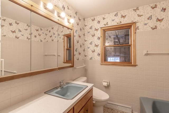468 Washington St, Le Center, MN 56057 - bathroom featuring wallpapered walls, toilet, tile walls, a wainscoted wall, and a tub