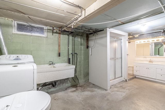 468 Washington St, Le Center, MN 56057 - bathroom featuring washer / dryer, concrete floors, a stall shower, toilet, and vanity
