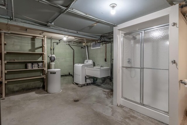 468 Washington St, Le Center, MN 56057 - unfinished below grade area featuring concrete block wall, a sink, a water softener system, and washer and clothes dryer