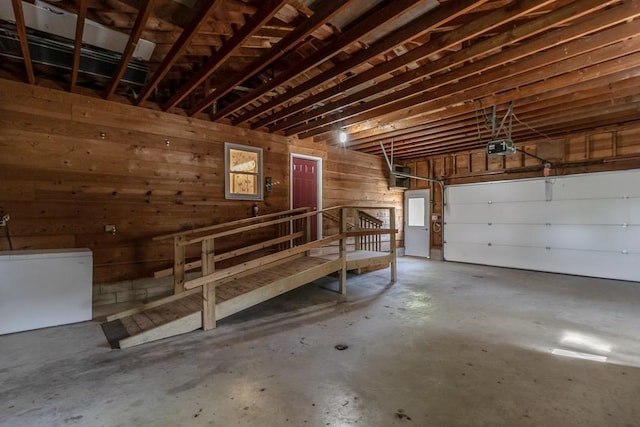 468 Washington St, Le Center, MN 56057 - garage with a garage door opener, fridge, and wooden walls