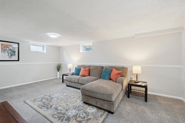 carpeted living room featuring a textured ceiling, plenty of natural light, and baseboards