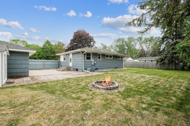 view of yard with a fire pit, a patio, and central air condition unit