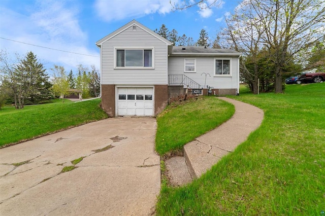 2505 Piedmont Ave, Duluth, MN 55811 - view of front of house with an attached garage, concrete driveway, and a front yard