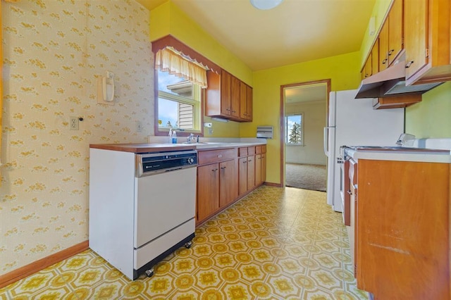 2505 Piedmont Ave, Duluth, MN 55811 - kitchen with dishwasher, baseboards, wallpapered walls, and brown cabinets