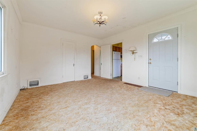 2505 Piedmont Ave, Duluth, MN 55811 - carpeted foyer featuring arched walkways, a chandelier, crown molding, and baseboards