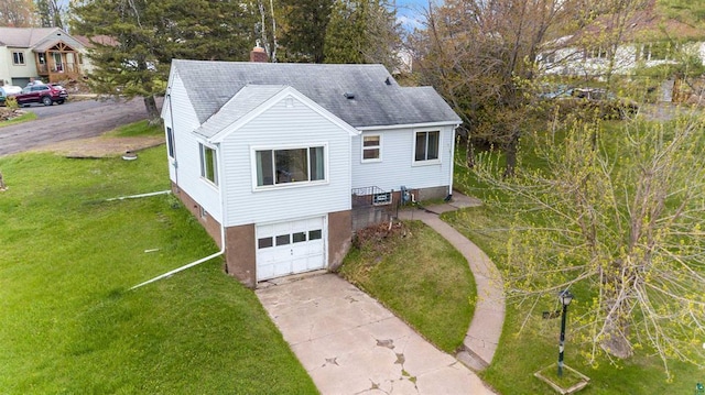 2505 Piedmont Ave, Duluth, MN 55811 - view of front of house with an attached garage, driveway, a chimney, a front lawn, and a shingled roof