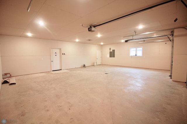garage featuring a garage door opener and electric panel