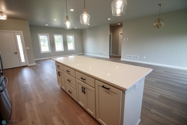 kitchen with open floor plan, light wood finished floors, white cabinetry, a kitchen island, and recessed lighting