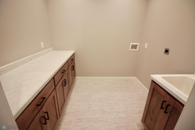 laundry room featuring electric dryer hookup, washer hookup, and baseboards