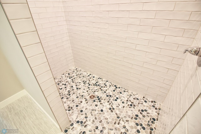 full bath with a tile shower