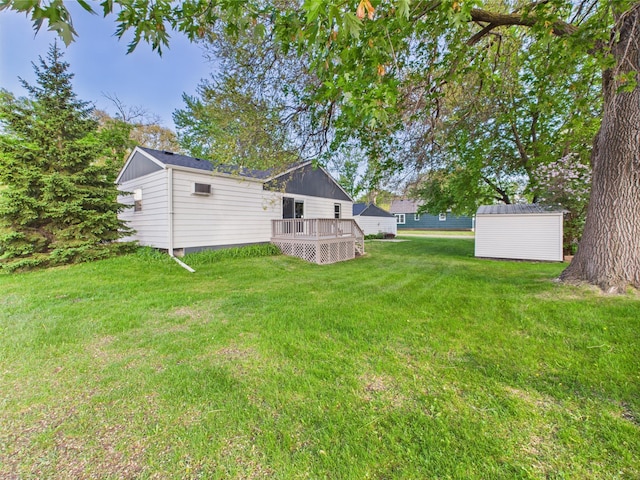3502 3rd St N, Saint Cloud, MN 56303 - view of grassy yard with a shed, an outdoor structure, and a deck
