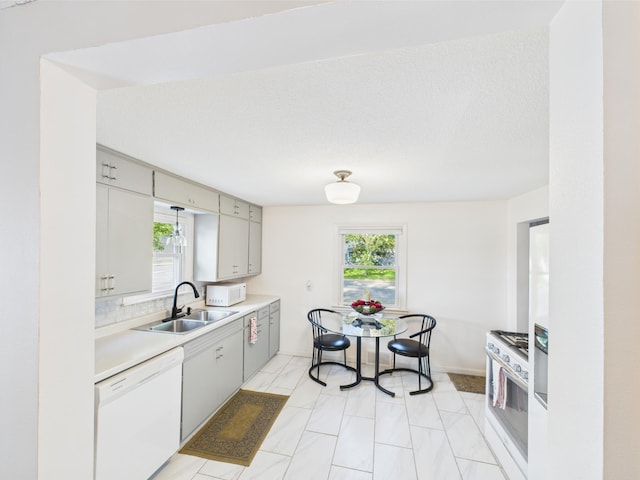 3502 3rd St N, Saint Cloud, MN 56303 - kitchen with white appliances, a sink, light countertops, and baseboards