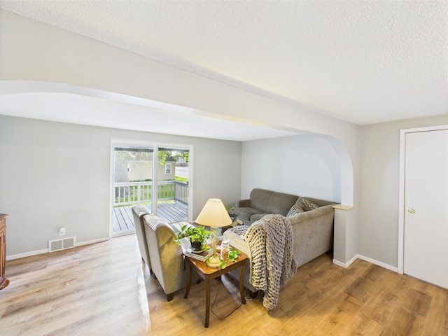 3502 3rd St N, Saint Cloud, MN 56303 - living area with light wood-type flooring, a textured ceiling, and baseboards