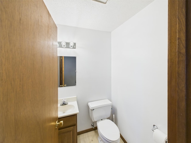 3502 3rd St N, Saint Cloud, MN 56303 - bathroom featuring toilet, vanity, baseboards, tile patterned flooring, and a textured ceiling