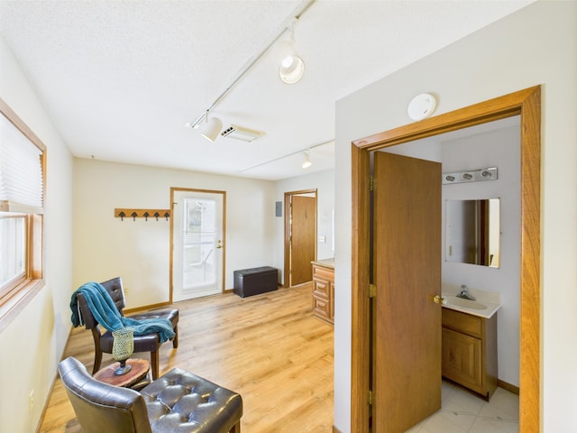 3502 3rd St N, Saint Cloud, MN 56303 - living area featuring track lighting, light wood-type flooring, and baseboards