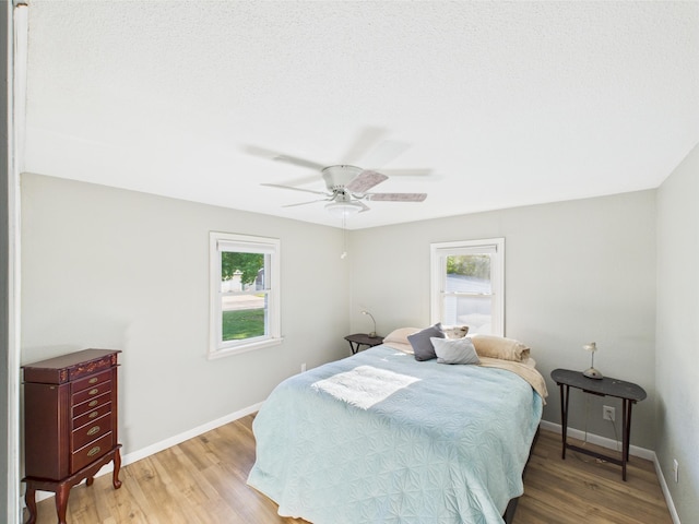 3502 3rd St N, Saint Cloud, MN 56303 - bedroom featuring multiple windows, wood finished floors, and baseboards