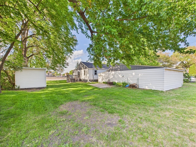 3502 3rd St N, Saint Cloud, MN 56303 - view of grassy yard featuring an outdoor structure and a storage shed