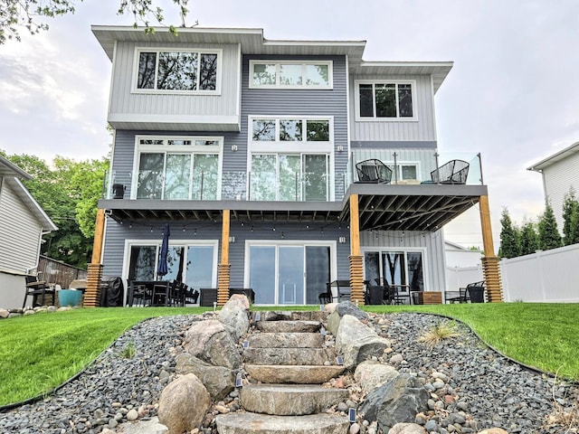 back of property with a balcony and board and batten siding
