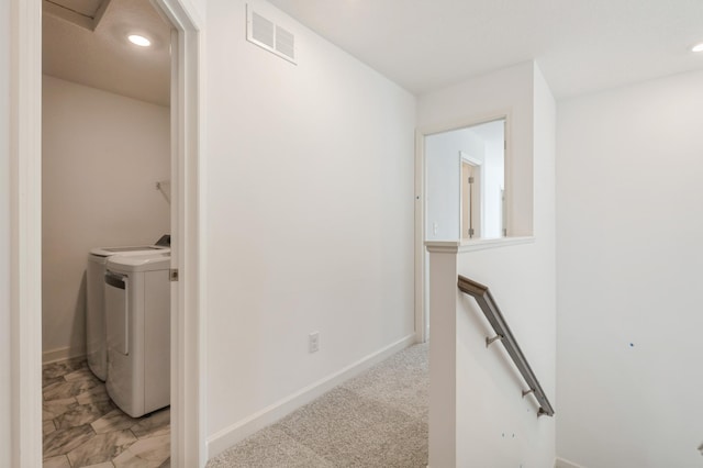 hallway with an upstairs landing, separate washer and dryer, recessed lighting, and baseboards