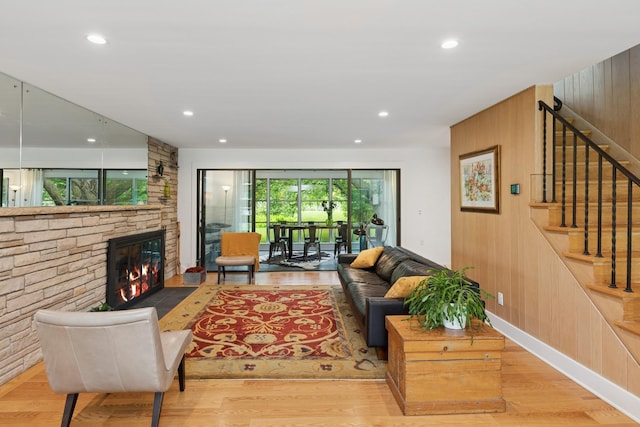 124 Paisley Ln, Golden Valley, MN 55422 - living room featuring wood finished floors, a fireplace, stairs, recessed lighting, and wooden walls
