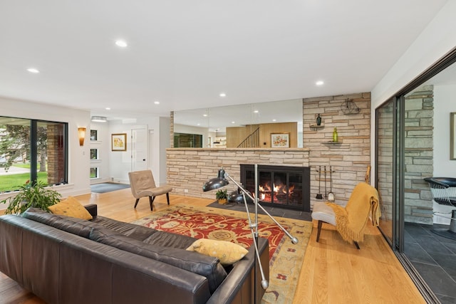 124 Paisley Ln, Golden Valley, MN 55422 - living area featuring wood finished floors, a stone fireplace, and recessed lighting
