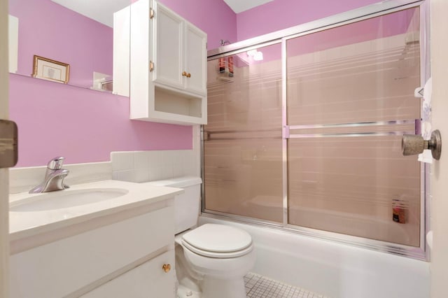 4201 Lakeside Ave N Unit 317, Brooklyn Center, MN 55429 - full bathroom featuring tile patterned flooring, vanity, combined bath / shower with glass door, and toilet