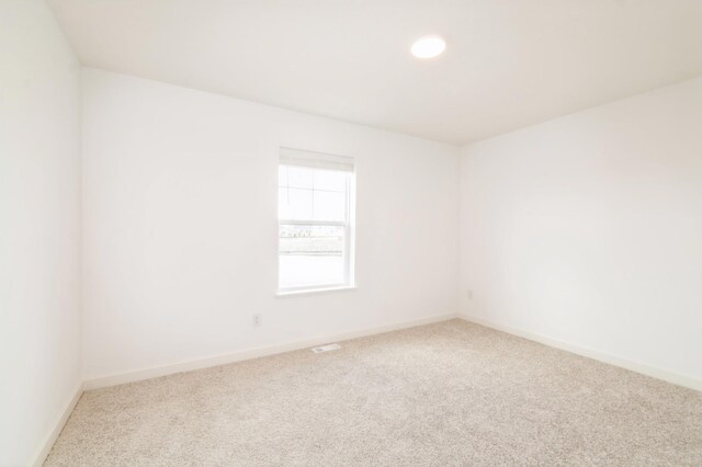 empty room with carpet floors, baseboards, and recessed lighting