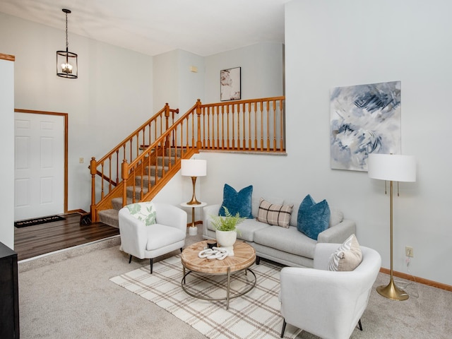 7808 Sunkist Blvd, Brooklyn Park, MN 55444 - carpeted living room featuring stairs, a chandelier, and baseboards