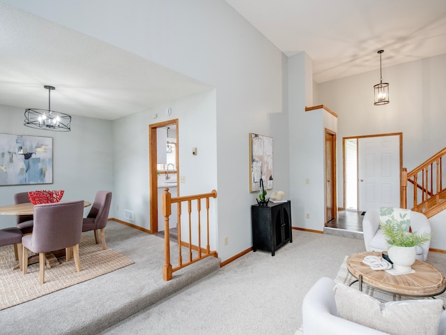 7808 Sunkist Blvd, Brooklyn Park, MN 55444 - living room featuring light colored carpet, a chandelier, baseboards, a towering ceiling, and stairway