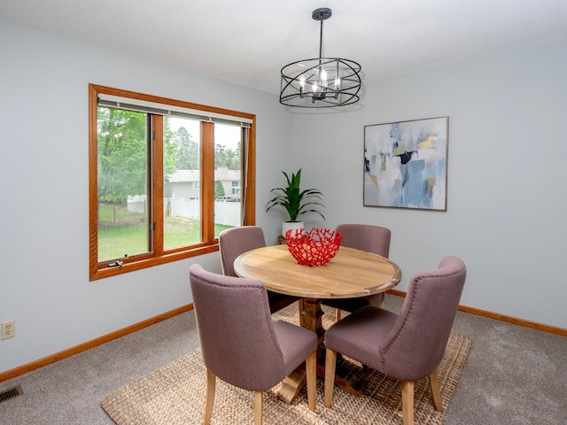 7808 Sunkist Blvd, Brooklyn Park, MN 55444 - carpeted dining space featuring a chandelier and baseboards