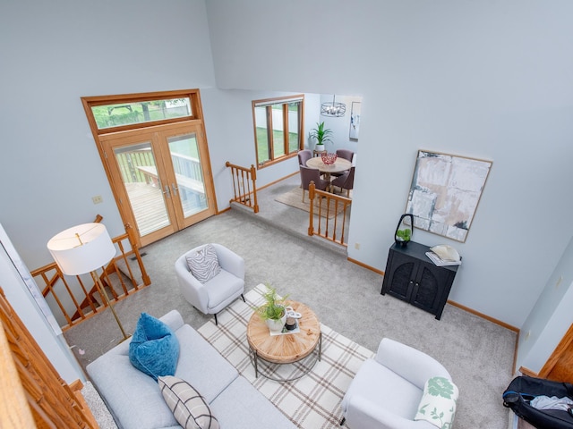 7808 Sunkist Blvd, Brooklyn Park, MN 55444 - carpeted living room featuring a chandelier, baseboards, french doors, and a towering ceiling