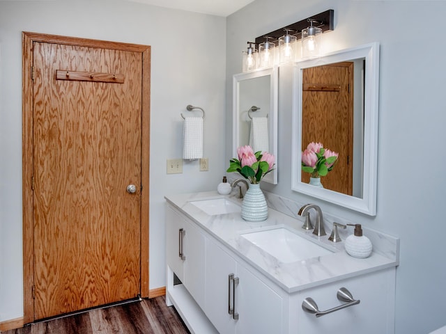 7808 Sunkist Blvd, Brooklyn Park, MN 55444 - bathroom featuring double vanity and wood finished floors