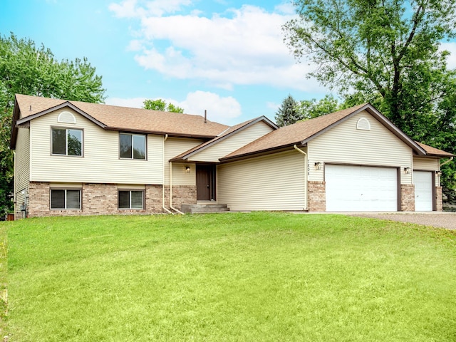 7808 Sunkist Blvd, Brooklyn Park, MN 55444 - split level home with a garage, asphalt driveway, a front yard, brick siding, and roof with shingles